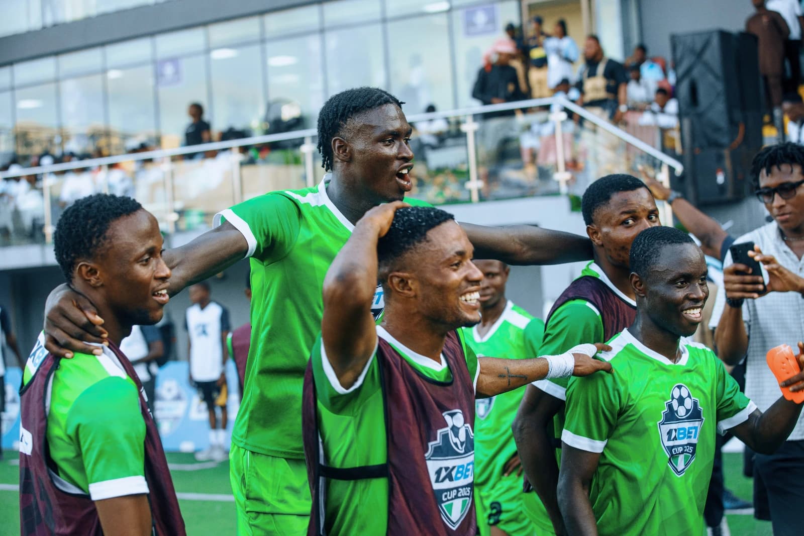 Football players celebrating in green kits